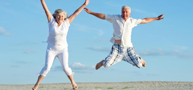 Couple jumping on the beach together